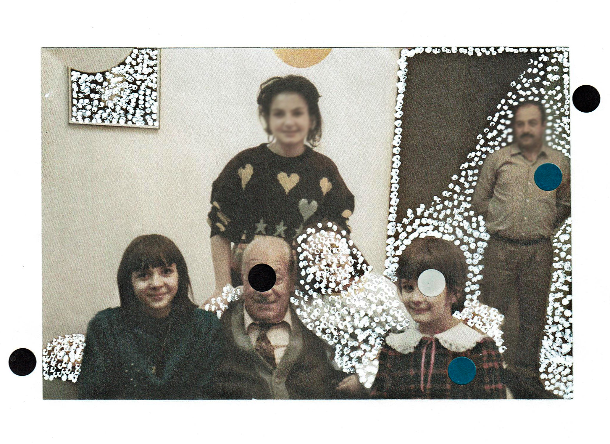 a photograph of a family is decorated with white, black and blue circles